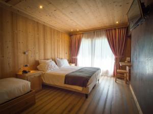 Postel nebo postele na pokoji v ubytování Hotel Funivia