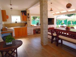 a kitchen with a table and a dining room at Holiday Home Villa Ivan in Umag