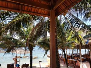 a view of the beach from a resort with palm trees at Free Beach Resort in Phú Quốc