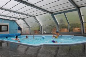 
a swimming pool with a large blue tub at Hotel Funivia in Bormio

