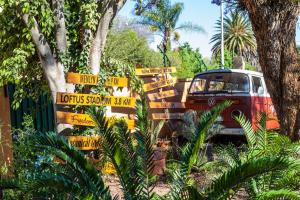 a bus parked next to a bunch of signs at 3@Marion Guest House in Pretoria