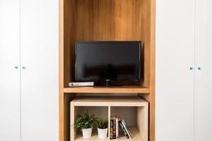 a tv sitting on a shelf in a room at Agora Apartments in Sorrento