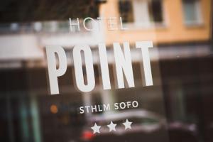 a reflection of a hotel sign on a window at Hotel Point in Stockholm