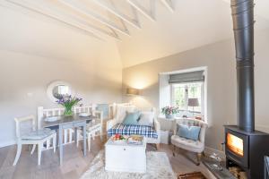 a living room with a table and a stove at The Lodge in Bath