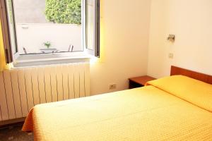 a bedroom with two beds and a window at Apartments Artemis Dubrovnik in Dubrovnik