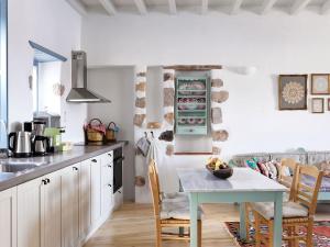 eine Küche mit einem Tisch und Stühlen im Zimmer in der Unterkunft Patmos Eye Traditional Luxury Villas in Skala