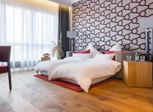 Postel nebo postele na pokoji v ubytování anders Kontorhaus Hotel