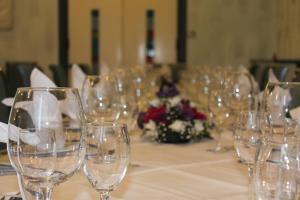 a bunch of wine glasses sitting on a table at Hotel Mediterraneo in Roccella Ionica