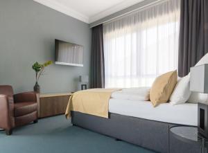 Postel nebo postele na pokoji v ubytování anders Kontorhaus Hotel
