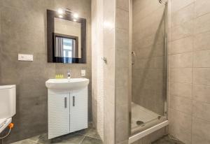 a bathroom with a sink and a shower at DayFlat Apartments Golden Gate Area in Kyiv +32 photos