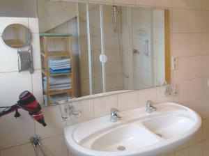 a bathroom with a sink and a mirror at Ferienwohnung Wiedmann in Tübingen