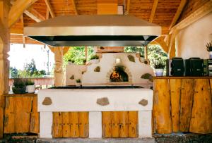 an outdoor oven with a stove in a building at Chaty Lesko-Ski in Lesko