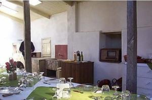 a large room with a table with wine glasses at Pousada Chácara das Roseiras in Bagé