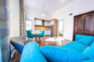 a living room with a blue couch and a table at Central Luxury 1 in Cluj-Napoca