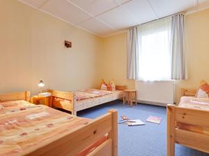 a room with three beds and a window at Tranquil Holiday Home in Zingst Germany with Terrace in Zingst