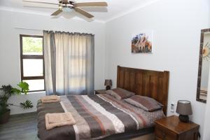 a bedroom with a bed and a ceiling fan at BELA Vic in Bela-Bela