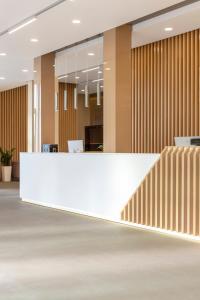 an office lobby with a white counter and wooden walls at ApartUA Кропивницький in Kropyvnytskyi