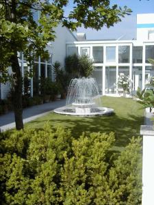 une fontaine dans une cour devant une maison dans l'établissement Lindemann Hotel, à Hildesheim