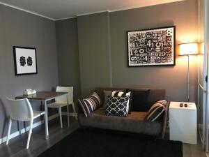 a living room with a couch and a table at D-condo mine in Kathu