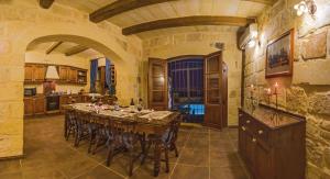 a large kitchen with a long table in a room at Blueberry Hills in Żejtun
