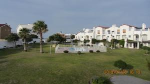 a large apartment complex with a swimming pool in a yard at The Tides 7 in Struisbaai