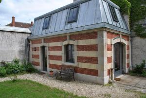 an old brick house with a blue roof at "Maison Schott" Studio in Nancy