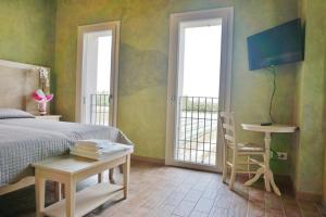 a bedroom with a bed and a table and a chair at agriturismo campogrande in Carpaneto Piacentino