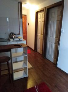 une cuisine avec un comptoir, une cuisinière et une porte dans l'établissement Condominio Doña Jacinta, à Valdivia