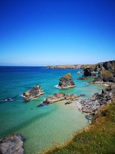 a view of the ocean with rocks in the water at Althea House with parking in Padstow
