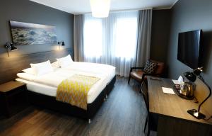
a hotel room with a bed and a desk at Alda Hotel Reykjavík in Reykjavík
