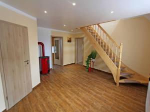 a hallway with a staircase in a house at Ferienhaus mit 3 Schlafraeumen Vor in Woldegk