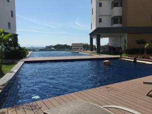 a swimming pool in front of a building at D Wharf Port Dickson Private Condo Waterfront in Port Dickson