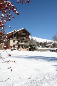 a building in the snow with snow at Hotel Le Chamois Logis in Molines-en-Queyras