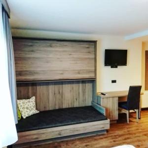 a room with a wooden wall with a desk at Die Reinbachstube in Sankt Johann im Pongau