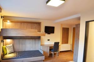 a room with a bed and a desk and a chair at Die Reinbachstube in Sankt Johann im Pongau +11 photos