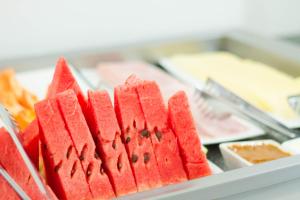 a bunch of red watermelon slices on a tray at Ok Inn Hotel Express in Tubarão