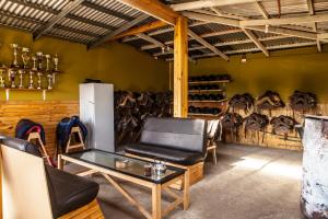 a room with a table and a chair and a wall of saddles at PAMPA HOSTEL in Torres del Paine