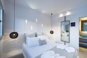 A bed or beds in a room at Quartano Luxury Cycladic Residence, Adults Only (13+)