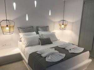 A bed or beds in a room at Quartano Luxury Cycladic Residence, Adults Only (13+)