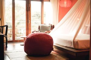 a bed in a room with a large window at iRoHa Garden Hotel & Resort in Phnom Penh