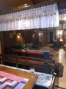a dining room with a table and a glass of wine at Sintonia do Mar in São Francisco do Sul +41 photos