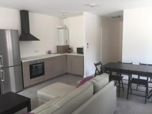 a living room with a couch and a dining room table at Villa Nature in Lacanau-Océan