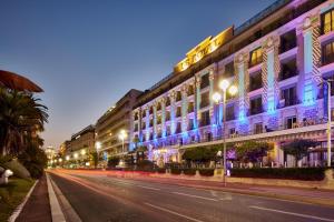 a city street at night with a building at Hôtel Le Royal Promenade des Anglais in Nice
