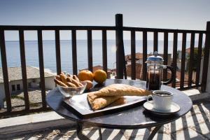 a table with a tray of food on a balcony at Panagopoulos House in Agios Ioannis Pelio