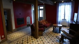 a living room with a couch and a table at Gîte Le Tournesac in Saint-Didier