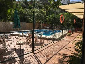 a swimming pool with a fence around it at La Despensa del Valle in Restábal