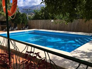 a swimming pool in a backyard with a fence at La Despensa del Valle in Restábal