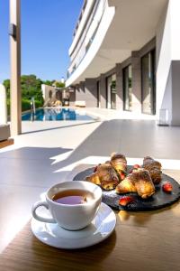 a plate of food and a cup of coffee on a table at Somewhere Vouliagmeni in Athens