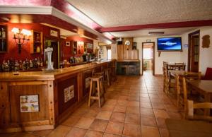 a bar in a restaurant with tables and chairs at La Era in Lario +13 photos