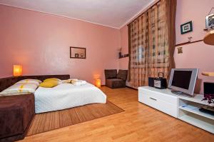 a bedroom with a bed and a desk with a television at STELA - One Bedroom Apartment in Rovinj